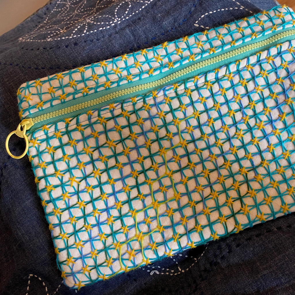 Zippered pouch stitched with Asagao Kugurizashi sashiko pattern
