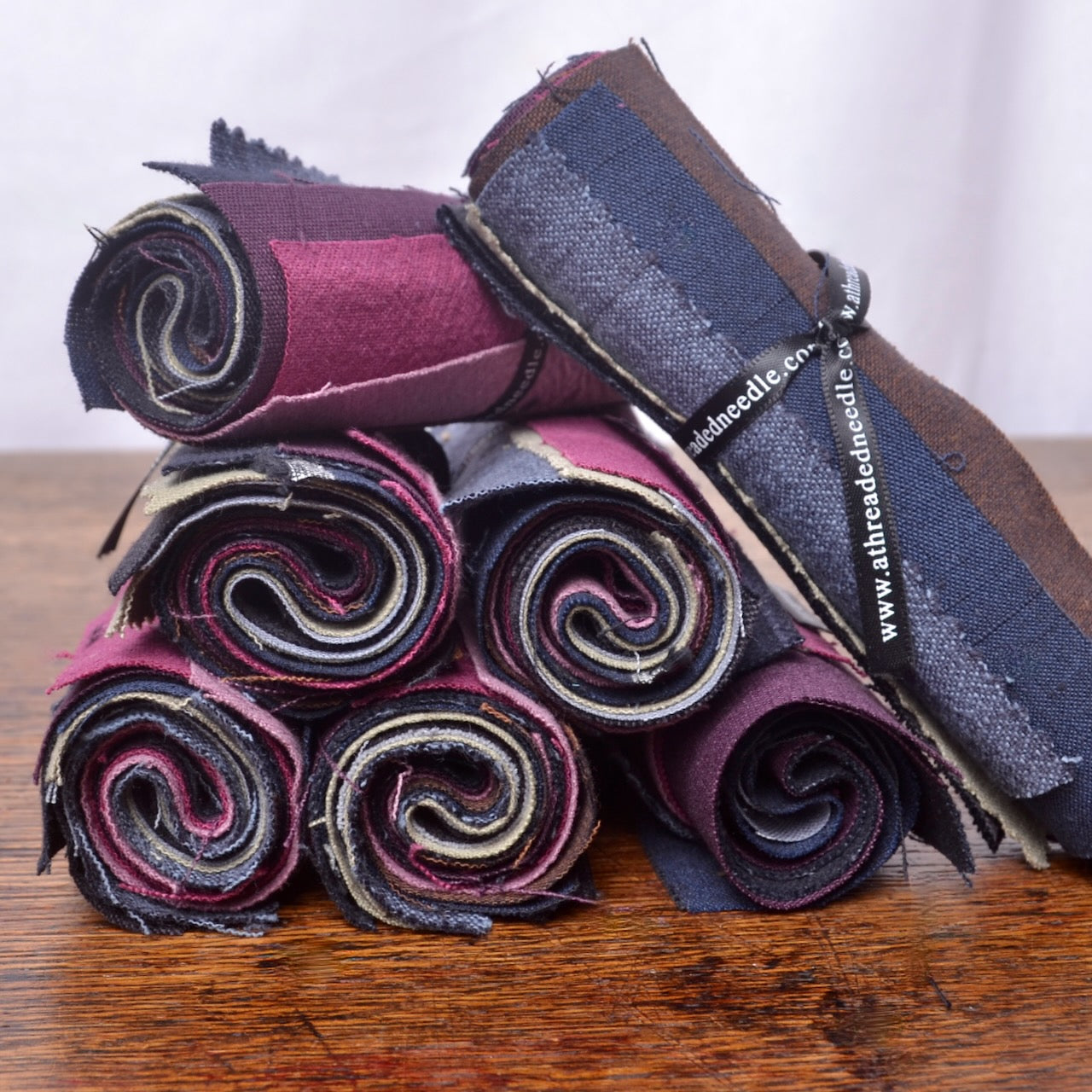 A mixed assortment of solid-colour cotton fabric pieces selected for visible mending, sashiko patches, stitch books, slow stitching and other hand-stitching projects.