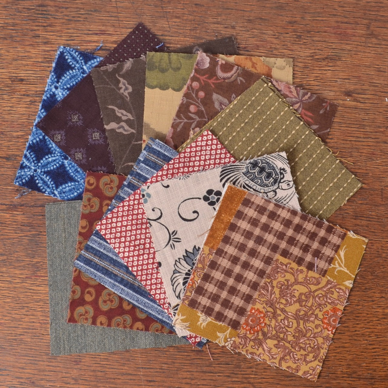 multiple fabric swatches with different patterns and colors, including japnese printed fabrics