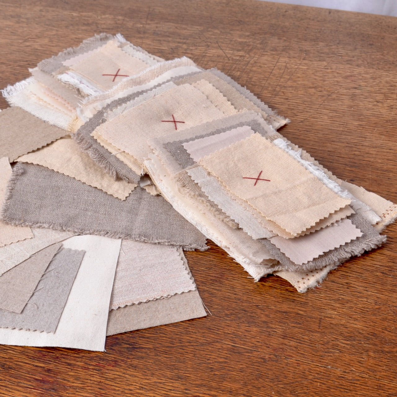 A beautiful collection of small pieces of assorted textures and colours of linen and cotton fabrics for mending or for hand stitchings.