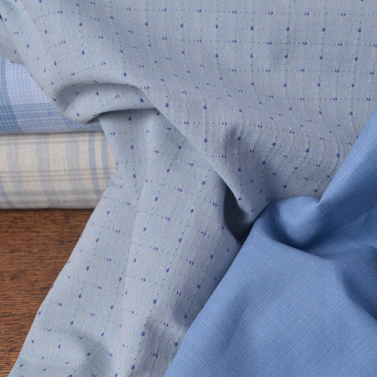 Yarn dyed cotton fabric and blue cotton dobby fabric shown togther, suitable for quilting, sewing clothing and applique