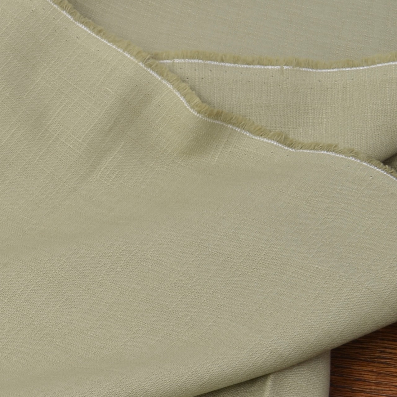 Green japanese cotton fabric showing salvage edge