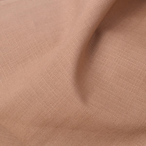 A close-up of draped dobby weave cotton fabric showing a subtle woven texture and soft folds.