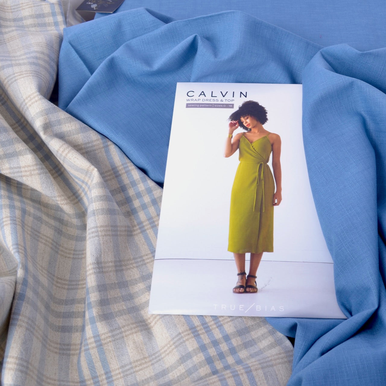 Calvin Wrap dress shown with blue dobby cotton fabric and a yarn dyed cotton fabric plaid
