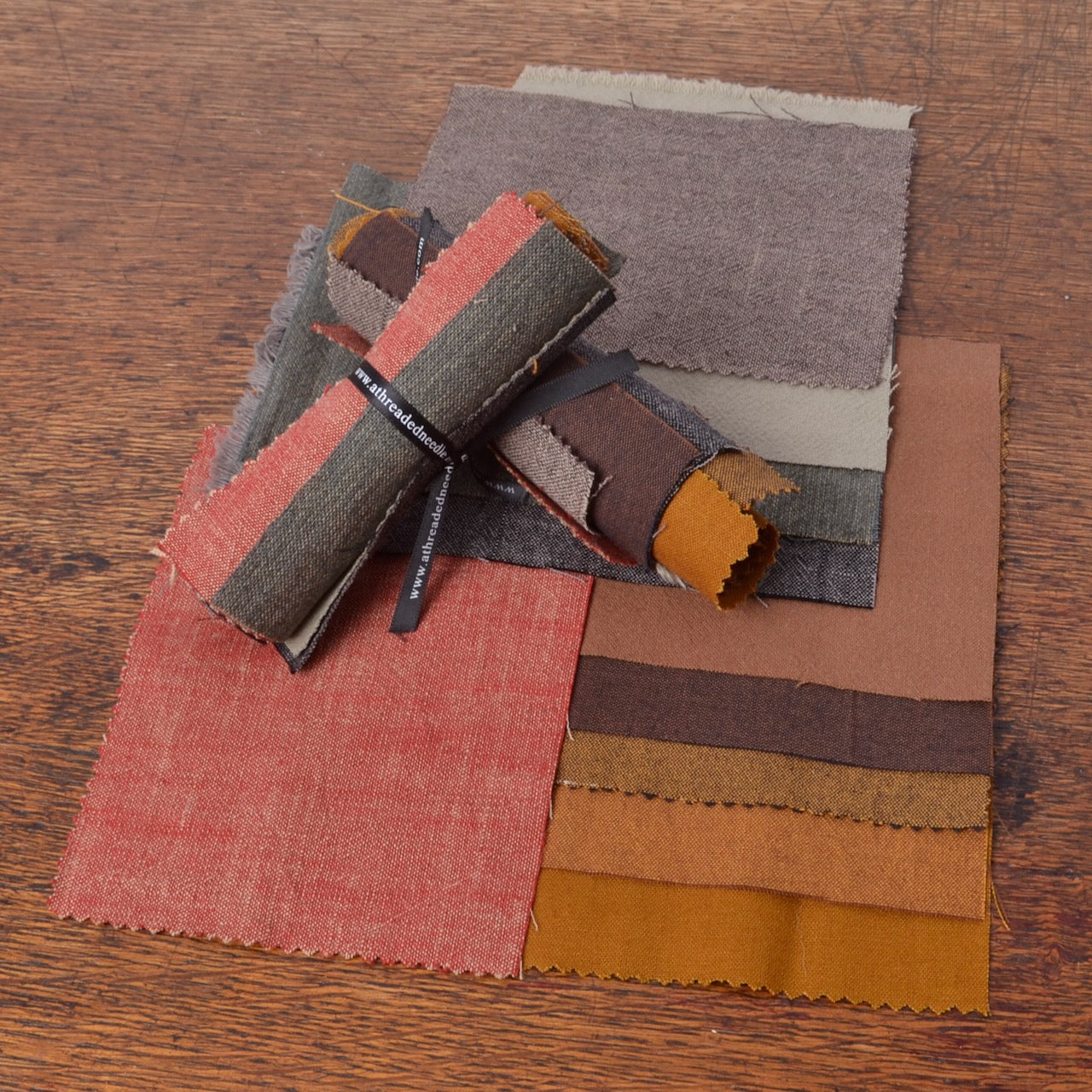Assorted Cotton Fabrics for Mending & Hand Stitching #2:  A collection of fabric swatches in earthy tones, including rust red, taupe, brown, mustard yellow, and grey.