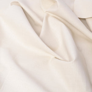 A close-up of draped off-white fabric with a subtle woven texture, showing soft folds and shadows.
