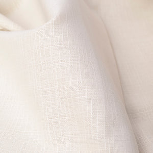 A close-up of draped off-white fabric with a subtle woven texture, showing soft folds and light shading.