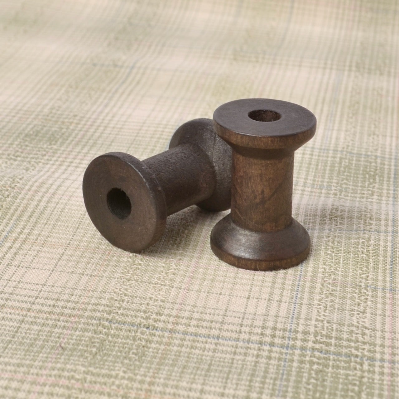 4 small wooden spools  (1 1/8" X 3/4")