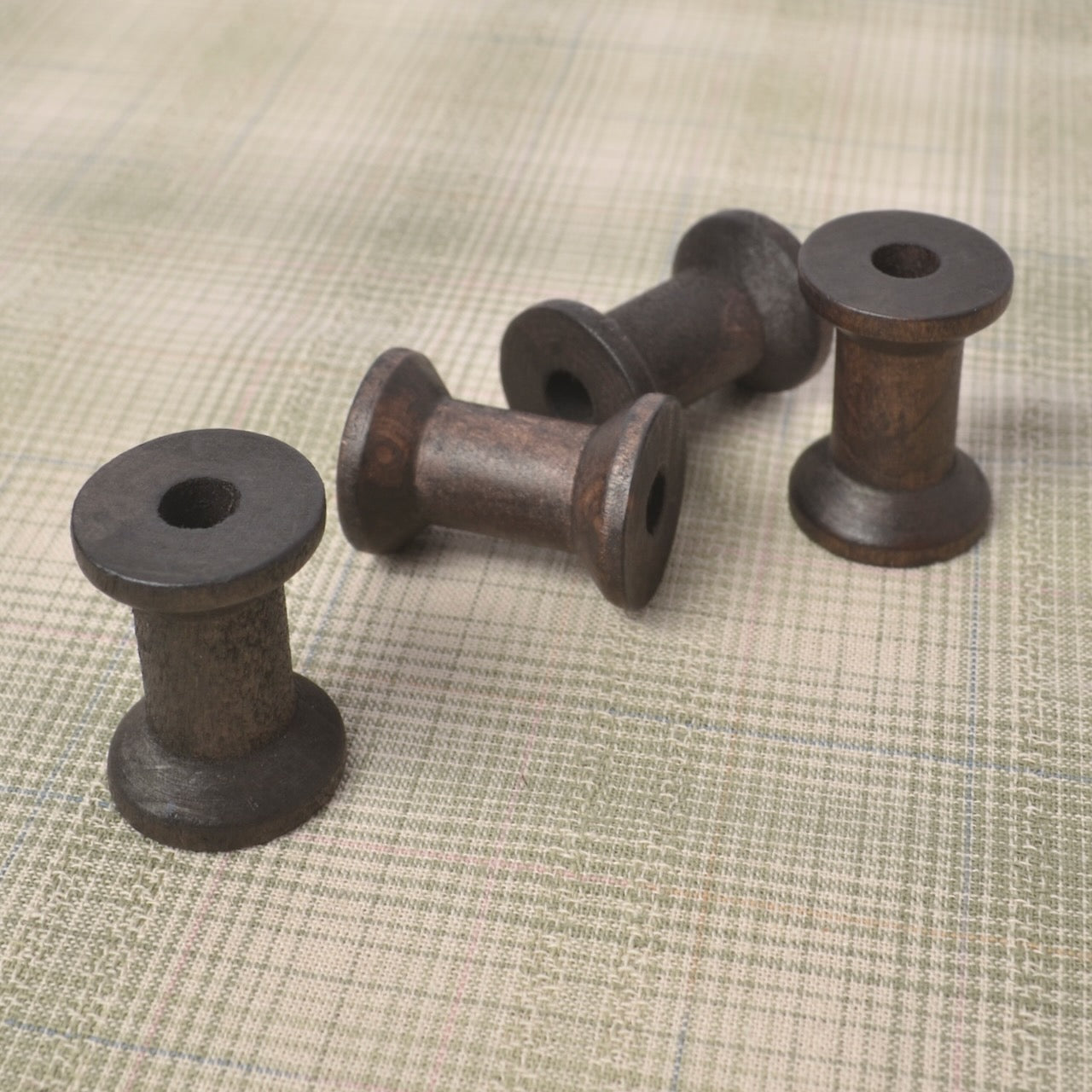 4 small wooden spools  (1 1/8" X 3/4")