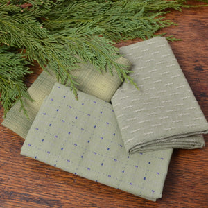 sewing fabric and cedar branch