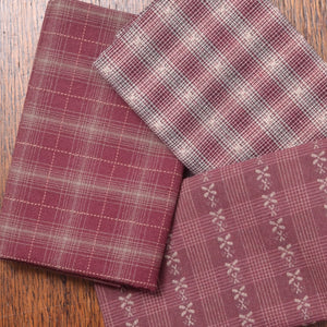 Bundle of three fat quarter pieces of yarn-dyed cotton fabric suitable for piecework