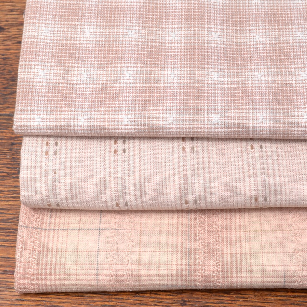 Bundle of three fat quarter pieces of yarn-dyed cotton fabric suitable for piecework
