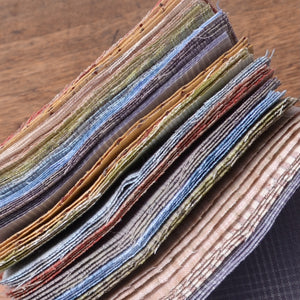 Showing edges of a pre-cut fabric pack, Japanese yarn-dyed  taupe cotton fabrics
