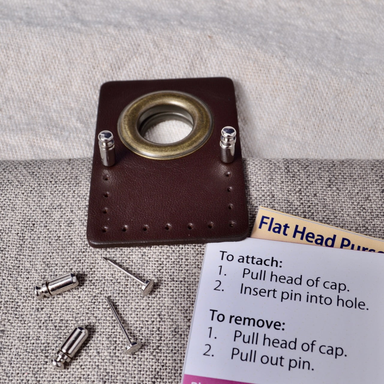 Flat Head purse pins holding grommet in place for sewing