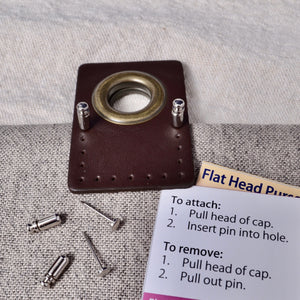 Flat Head purse pins holding grommet in place for sewing