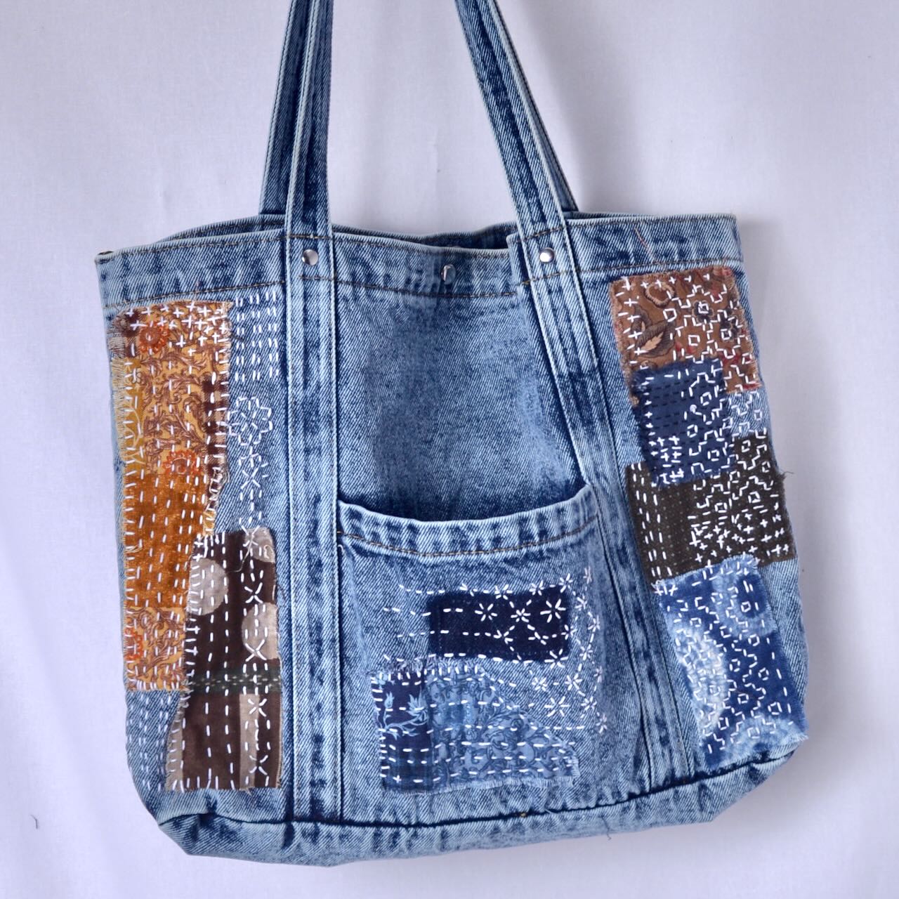 Example of denim tote bag blank stitched with boro inspired patching and sashiko stitching 