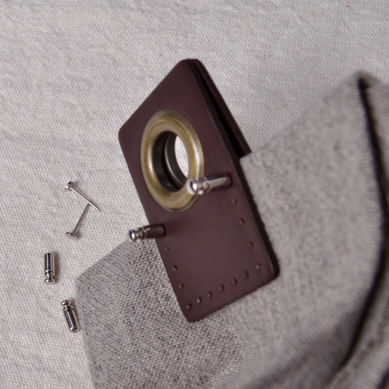 Flat Head Pins fixing leather grommet in place