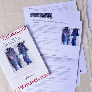 Bella Bold reversible vest pattern with instructions on a beige fabric background