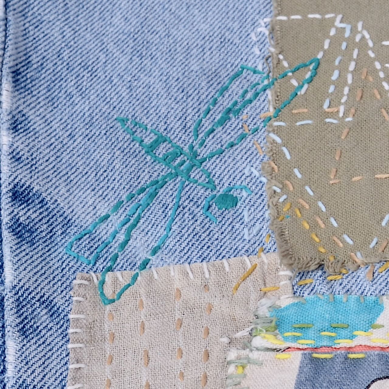 Peel, Sick & Stitch "Sashiko Dragonflies" on worn bue jeans