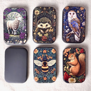 five small metal tins with animal and flower designs