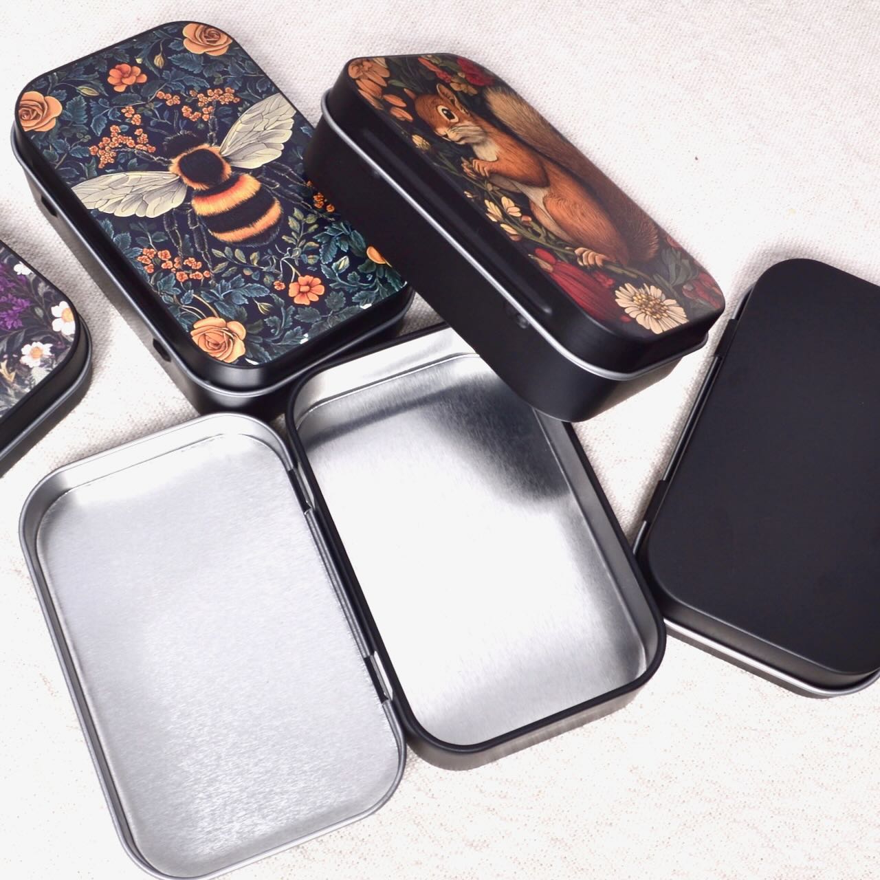 Decorative metal tins with floral and animal designs 