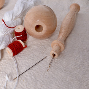 darning egg with detachable handle and chamber for keeping sewing needles
