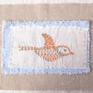 sashiko thread stitching of bird on cotton, ramie and linen fabric layers, unfinished