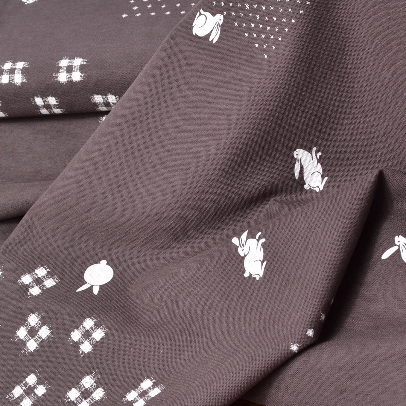 brown cotton  kasuri print fabric with bunnies