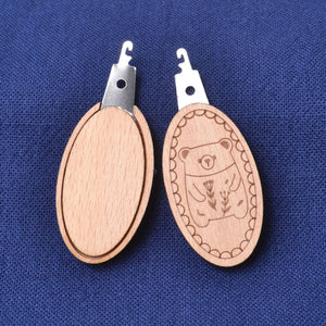 Needle Threader "Wood Bear" showing front and back sides