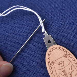 Needle Threader "Wood Bear" with needle being threaded
