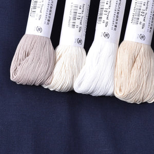 4 white sashiko threads compared on navy blue fabric