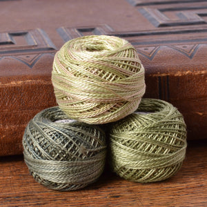 Various green perle cotton threads