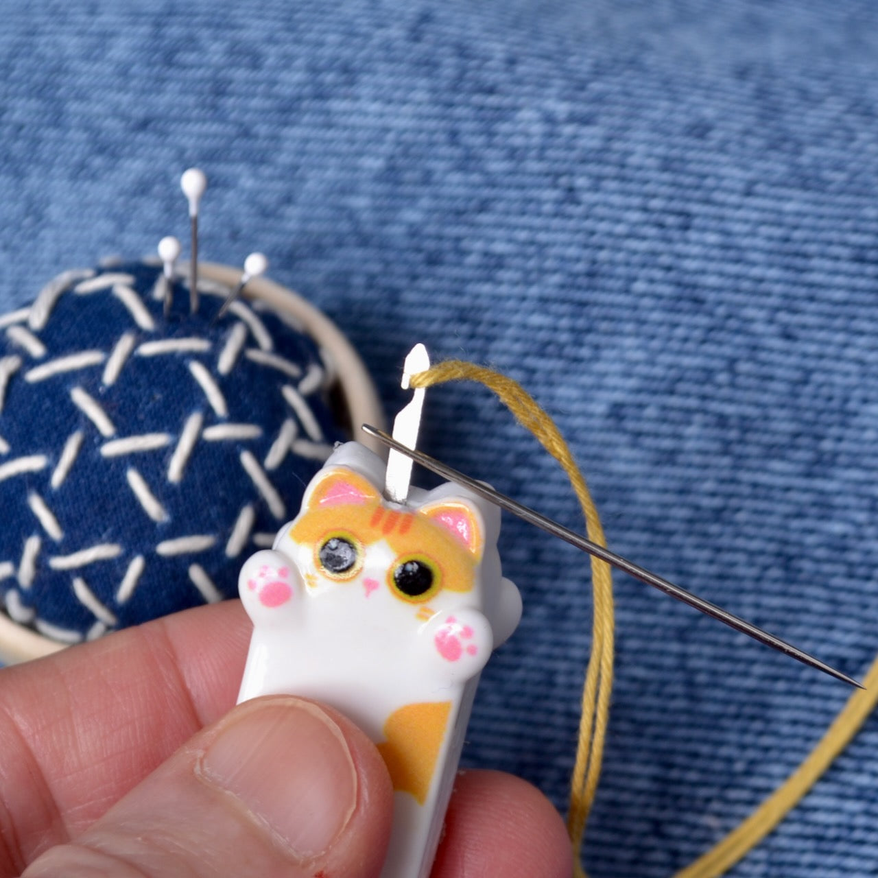  showing step 1 for how to use cute kitten needle threader