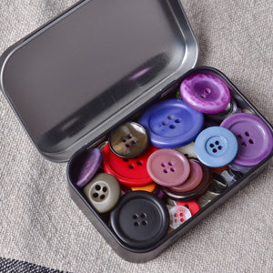 mall tin box containing mixed buttons