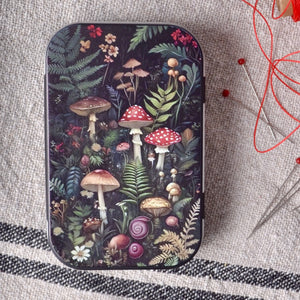 mall tin box has a charming&nbsp; mushroom and fern forest design on the hinged lid.
