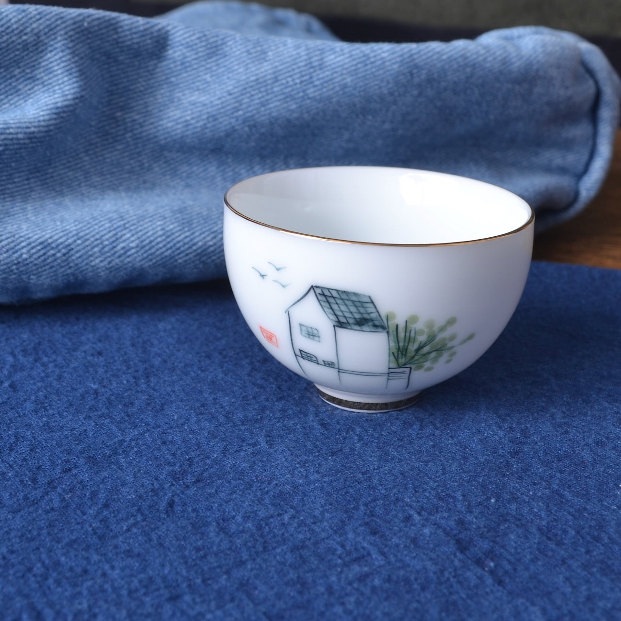 tea bowl on indigo dyed cotton fabric