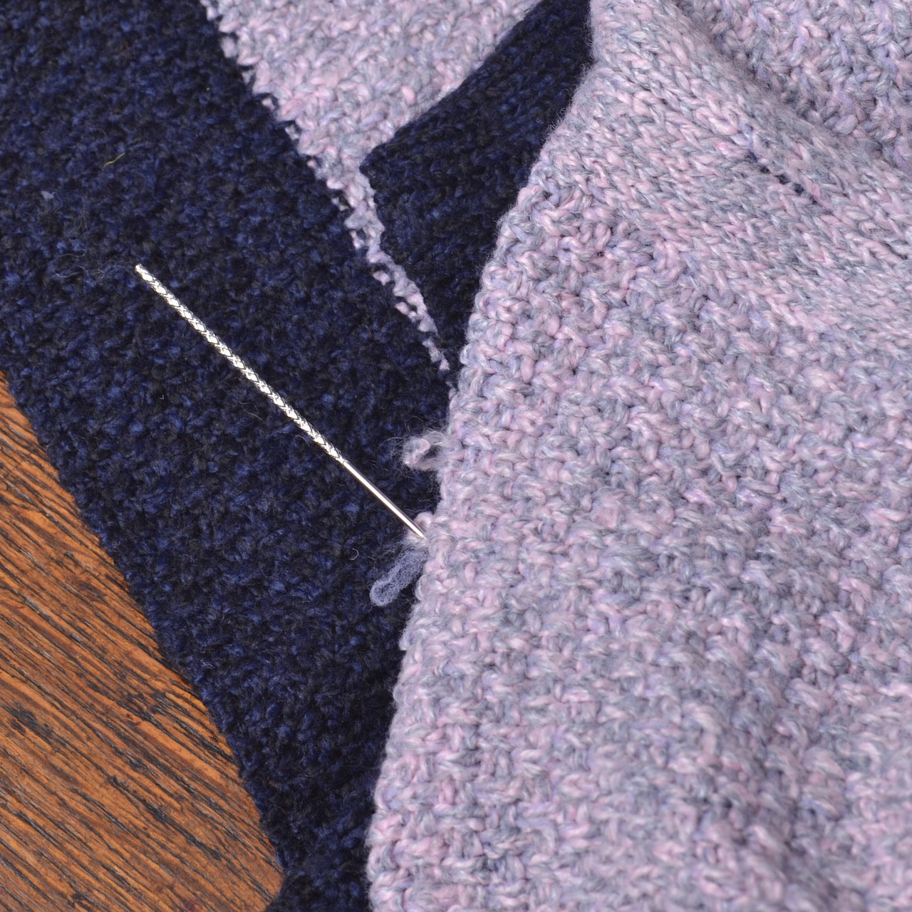 showing snagged threads on knit fabric being fixed with snap repair needle