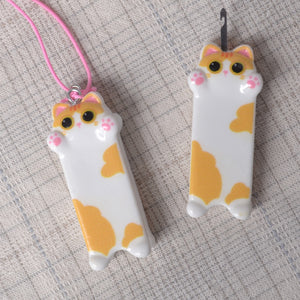 showing cute kitten  needle minder and needle threader