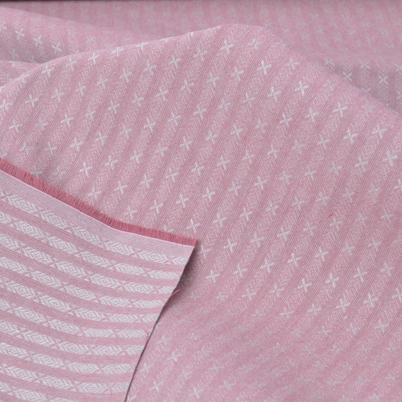 Close-up of pink fabric with white pattern