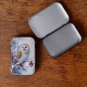 Small tin box with owl design on the surface