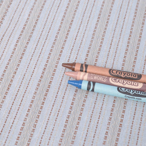 Three Crayola crayons on dyed yarn cotton fabric to show colours