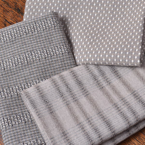 Three gray textured cotton fabrics with different patterns 