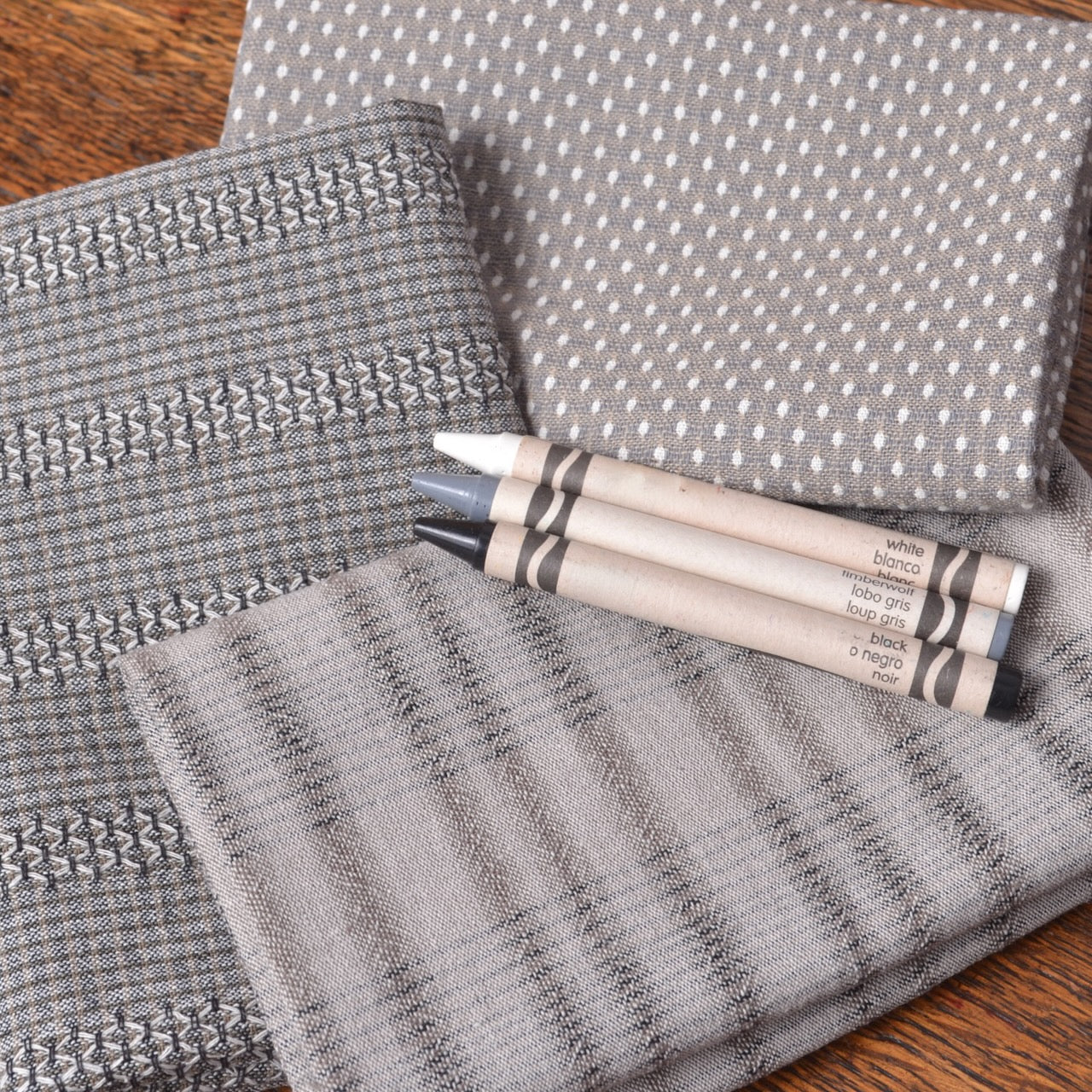 Three gray fabric fat quarters with different patterns 