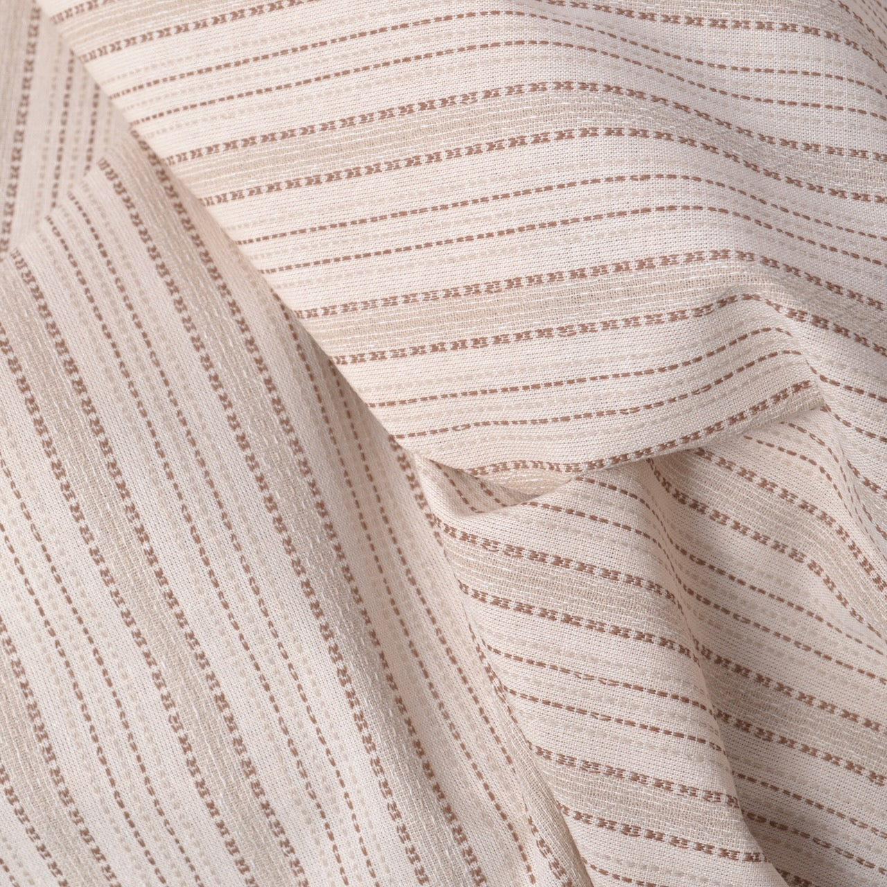 Close-up of beige fabric with subtle pattern