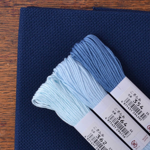 Kogin Stitching, 18 Count Navy Blue Congress Cloth shown with kogin threads