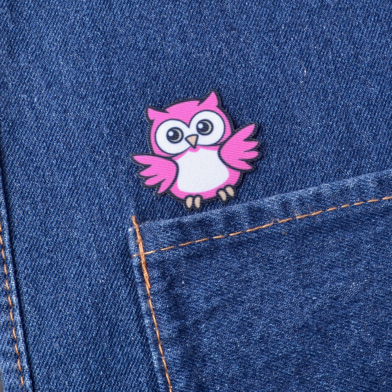 Pink iron on owl patch on a blue denim fabric
