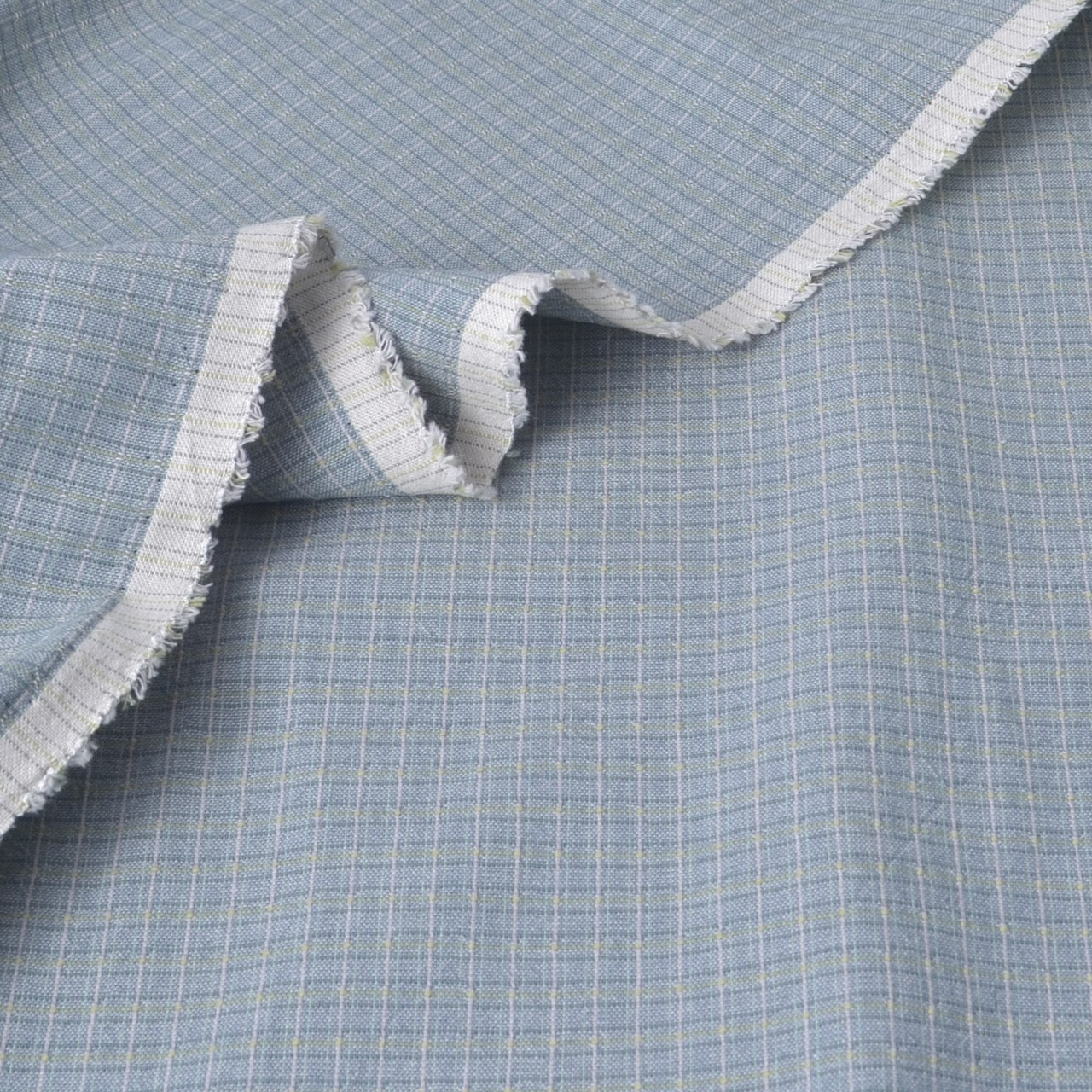 Light blue and white cotton fabric salvage edge to show texture and weave.