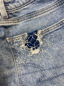 Close-up of a blue denim pocket with sashiko mending