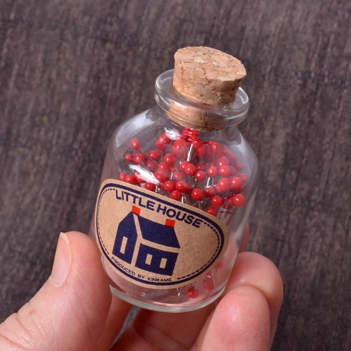 red Little House pins in a bottle