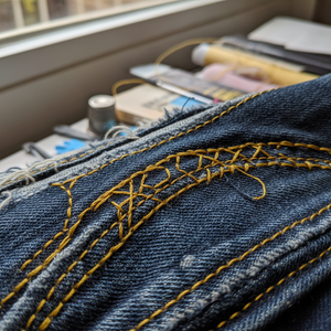 Yellow top stitching on denim seam
